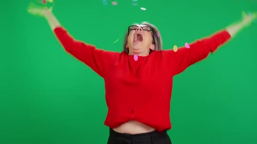 Enthusiastic Woman Celebrates Under Shower of Colorful Confetti