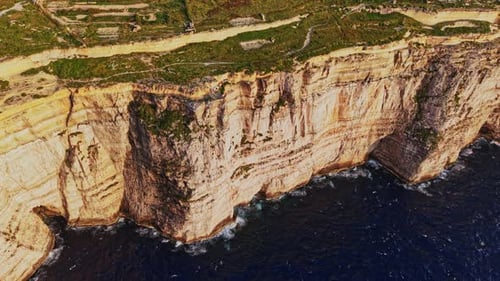 Breathtaking aerial view of the rugged cliffs of Malta overlooking the sea