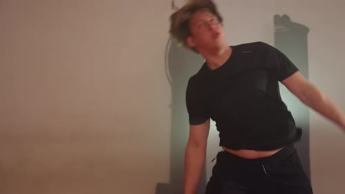 Gymnast Does Cartwheel in Weight Room with Dumbbells