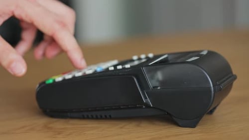 Hand using credit card machine for transaction
