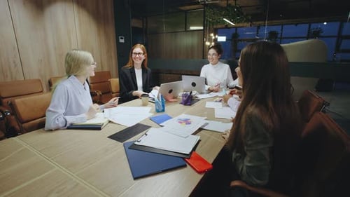 Women Collaborate in Modern Office Conference Room