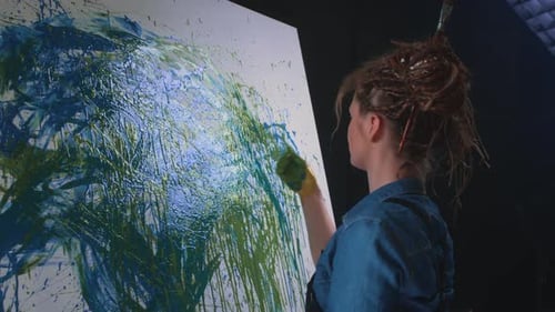 Artist Creating Abstract Painting with Hands in Studio