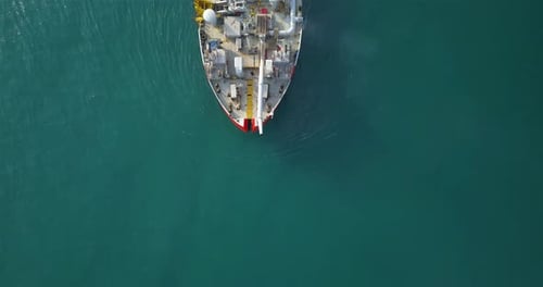 Dredging Ship Sailing on Teal Ocean, Birds Eye View