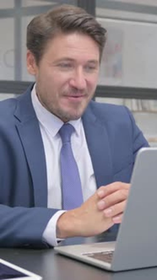 Man in Suit Having Video Call on Laptop
