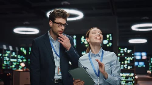 Colleagues Discussing Technology in Modern Office Environment