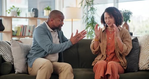 Man and Woman Arguing on Couch in Living Room