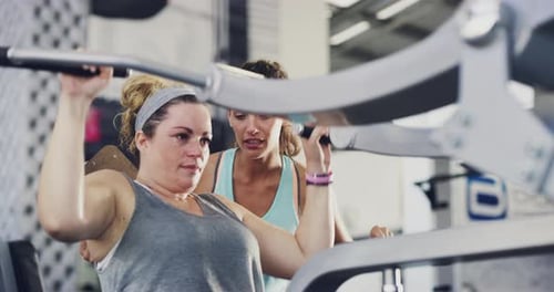 Real people training, normal person with a coach, personal trainer or gym instructor.