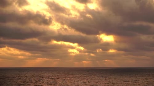Sea Horizon Line with Waves on Golden Sunset