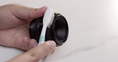 Cleaning camera ring with toothbrush