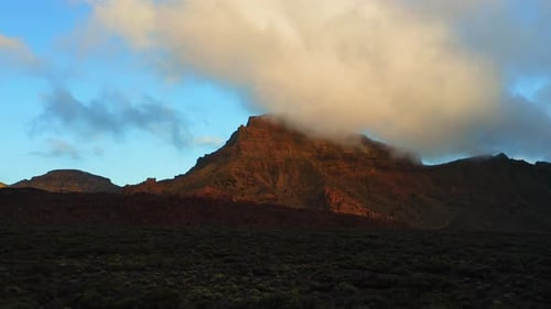 Aerial Sunset Rays Illuminating Hot Desert Mountain Landscape on White Cloudy Sky Background in