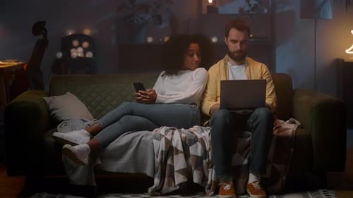 Woman and Man on Couch Use Technology