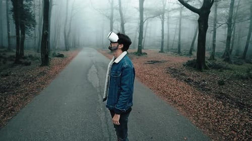 Man Using VR Headset in Misty Autumn Forest