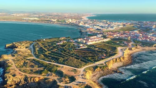 Pull Back Revealing Drone Shot Peniche Town Cliffs and Sunset Portugal