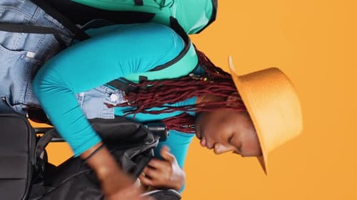 Woman Packing Travel Bag for Vacation in Studio