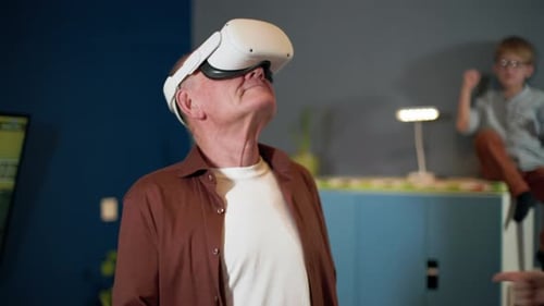 Senior Man Enjoys Virtual Reality Gaming with Grandson