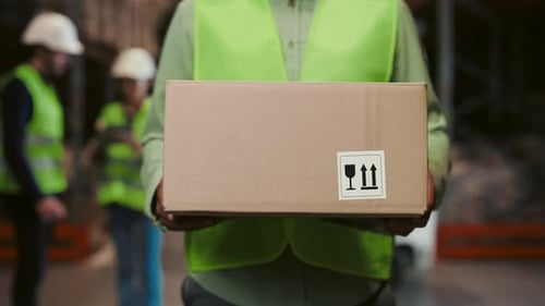 Worker Hands Holding Cardbox in Warehouse Walking in Logistic Centre