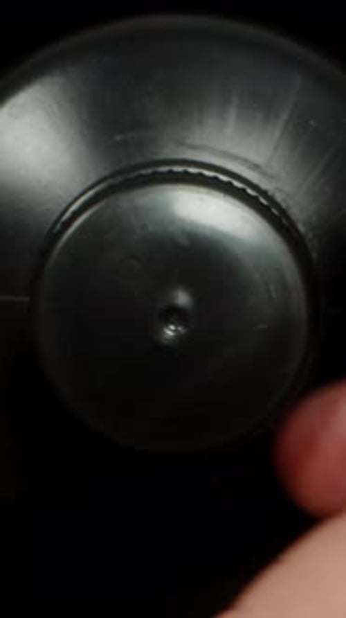 Vertical video. Inside A Black Bottle, Camera Rises Up And The Lid Is Screwed On. Dolly Slider,