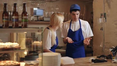 Two Cafe Workers are Loudly Arguing and Squabbling While Standing at Their Workplace Behind the