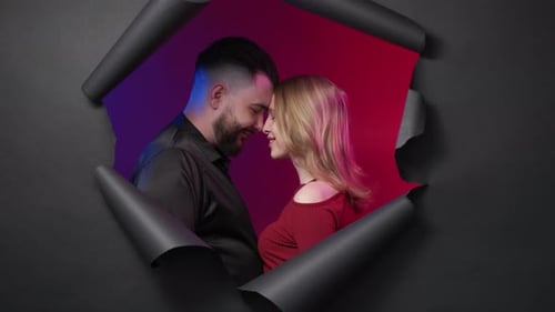 Young Couple Posing in Front of Red and Blue