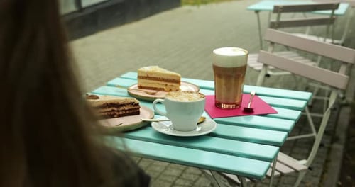 Cake and Coffee at an Outdoor Cafe