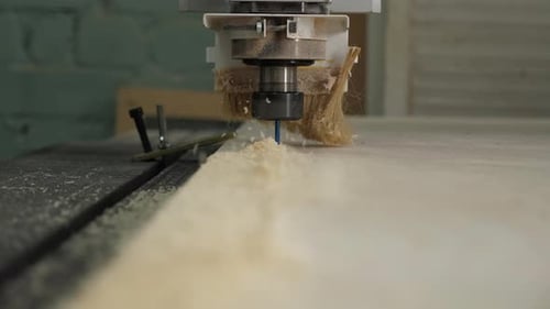 Closeup of a Powerful Wood Cutter Working with Plywood in a Carpentry Workshop