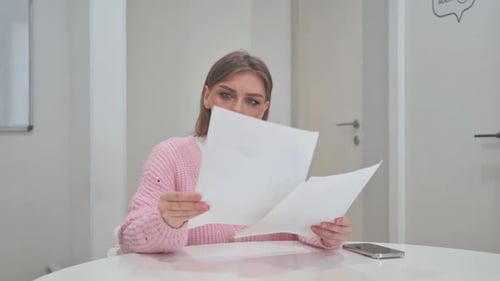 Business Woman Reading Annual Business Report of Company