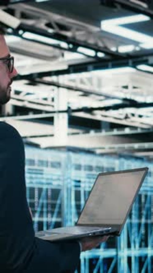 Vertical Video Data Center Software Developer Writing Code Optimization Using Laptop