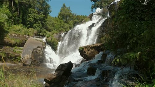Scenic Waterfall Flowing Through Lush Green Forest Landscape Natural