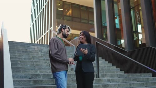 Business People Discussing Tablet on Urban Steps