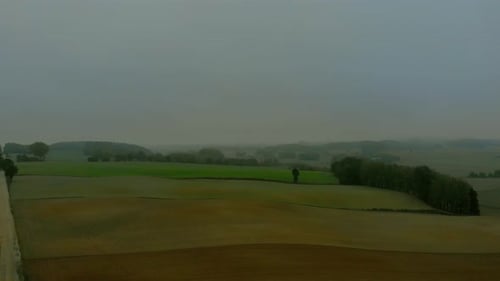 Aerial View of Rolling Farmland with Dirt Road