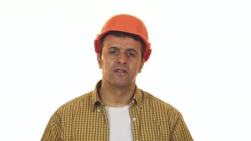 Shocked Construction Worker Removing His Hardhat in Disbelief