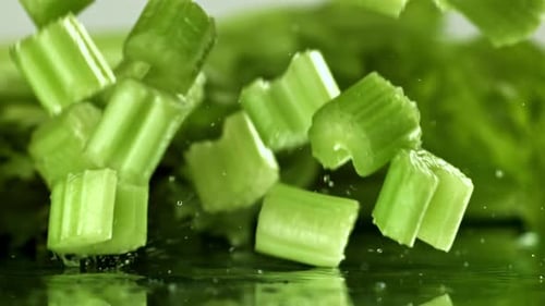 Sliced Pieces of Fresh Celery Fall on the Table Filmed on a Highspeed Camera at 1000 Fps
