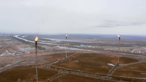 A complex of high-altitude burning torches at a gas production plant.