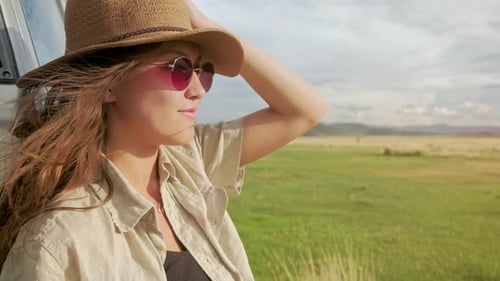 Woman Relaxing in Rural Setting during Road Trip