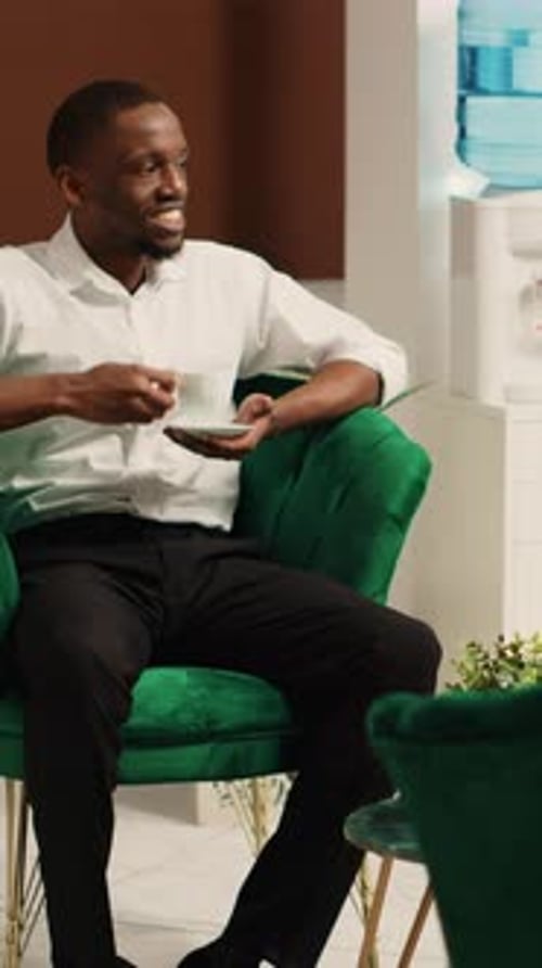 Vertical Video G Uests Awaiting Bellboy in Hotel Lobby