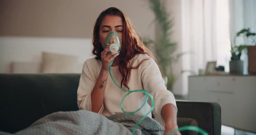 Woman Uses Nebulizer Breathing Treatment at Home