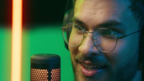 Close Up Smiling Talking in Mic Radio Host Worker Gamer Streamer Night Gaming Neon Game Addiction at