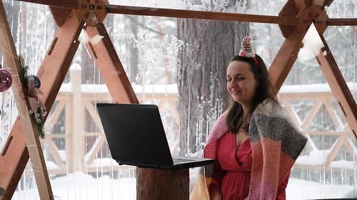 Woman Video Calling at Christmas in Snowy Gazebo