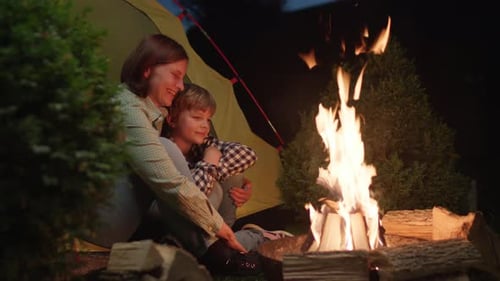 Mother and Kid Talking Sitting in Tent By Campfire Evening Camping Fire Family Enjoys Time Sitting