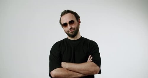 Man Wearing Sunglasses With Arms Crossed Poses