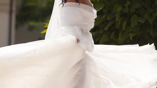 Woman Walks in White Dress on Sunny Day