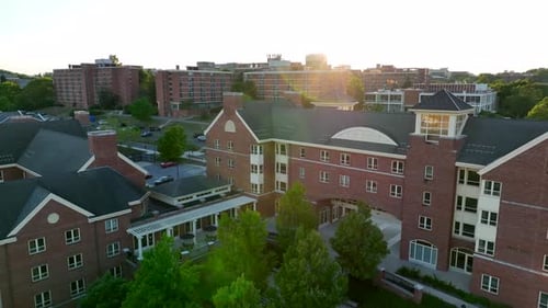 College dorm buildings in USA. Pullback aerial reveal at sunset.