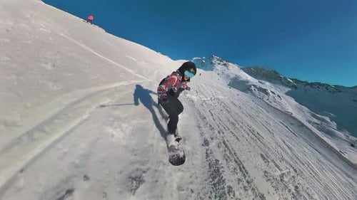 Freeriding snowboard. Professional snowboarder ride down the mountain slope at sunny winter day in F
