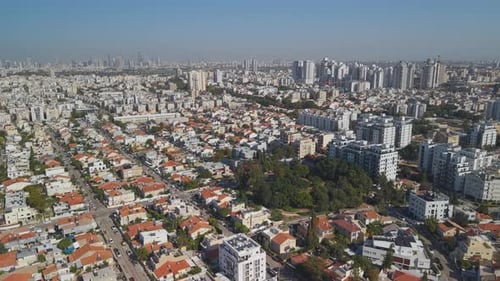 Aerial View of Sunlit Urban Cityscape and Dense Residential Neighborhoods