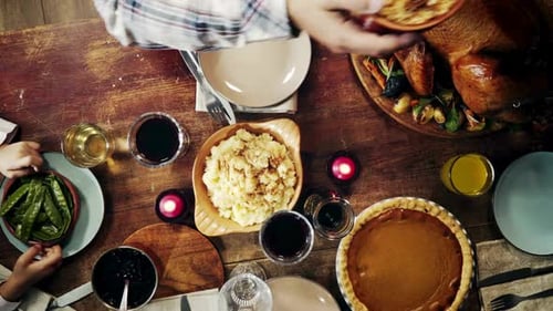Overhead Shot Family Sharing Thanksgiving Dinner at Home