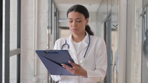 Portrait of African Female Doctor Working on Medical Report