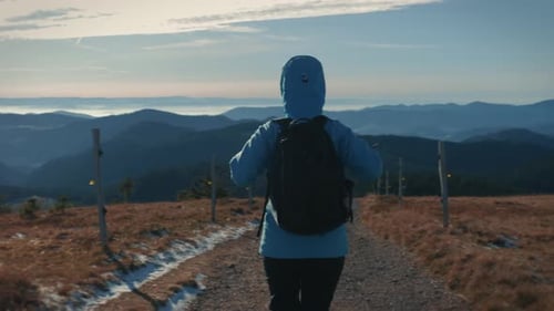 Person Hiking in the Mountains on Dirt Path