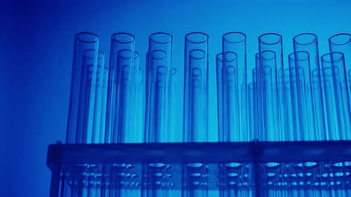 Close Up Video Neon Blue Light Test Tubes in a Laboratory Scientific Experiment Research Study