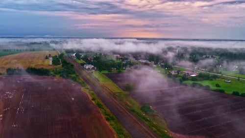 Aerial View of Foggy Rural Village at Sunrise
