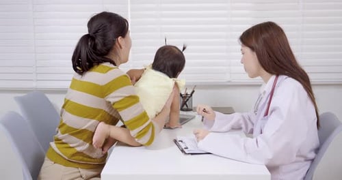Mother and Baby with Doctor During Check Up